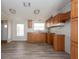 Simple kitchen with wood cabinets and vinyl flooring at 38029 Leondias Dr, Zephyrhills, FL 33542