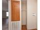 Laundry closet with wood cabinet and shelving at 38029 Leondias Dr, Zephyrhills, FL 33542
