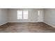 Bright living room featuring wood-look flooring at 38029 Leondias Dr, Zephyrhills, FL 33542