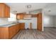 View of kitchen with wood cabinets and vinyl flooring at 38029 Leondias Dr, Zephyrhills, FL 33542