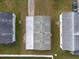 An aerial view showcasing a home's roofline, backyard, and neighboring properties at 38029 Leondias Dr, Zephyrhills, FL 33542