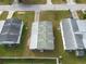 Aerial view of a home, highlighting its roof, landscaping, and surrounding area at 38029 Leondias Dr, Zephyrhills, FL 33542