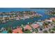 Stunning aerial view of waterfront property with lush landscaping, boat docks, and sunny blue water at 4380 44Th S St, St Petersburg, FL 33711