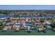 Aerial view of waterfront homes, lush greenery, and canals in a sunny neighborhood at 4380 44Th S St, St Petersburg, FL 33711