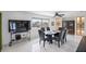 Bright dining area features tile floors, sleek black table with seating for six, and views of the waterfront at 4380 44Th S St, St Petersburg, FL 33711