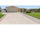 Charming single-story home with a well-manicured lawn and a long driveway leading to an attached two-car garage at 4380 44Th S St, St Petersburg, FL 33711