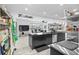 Kitchen open to dining area featuring black cabinetry, stainless steel appliances, and waterfront views at 4380 44Th S St, St Petersburg, FL 33711