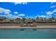 Beautiful pool area with waterfront views under a bright blue, partly cloudy sky at 4380 44Th S St, St Petersburg, FL 33711