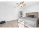 Main bedroom with grey bedding and ceiling fan at 12251 Snowy Egret Ave, Weeki Wachee, FL 34614