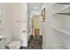 Clean bathroom with toilet, shower, and linen storage at 131 114Th Ne Ter # 131, St Petersburg, FL 33716