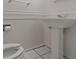 Small half bathroom with pedestal sink and toilet at 131 114Th Ne Ter # 131, St Petersburg, FL 33716