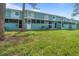 Exterior view of building with landscaping and lawn at 131 114Th Ne Ter # 131, St Petersburg, FL 33716
