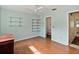 Bedroom with wood floors, ceiling fan, and access to bathroom at 131 114Th Ne Ter # 131, St Petersburg, FL 33716