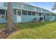 Building exterior showcasing a teal color scheme and lawn at 131 114Th Ne Ter # 131, St Petersburg, FL 33716