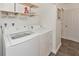 White washer and dryer with shelving in laundry room at 131 114Th Ne Ter # 131, St Petersburg, FL 33716