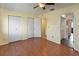 Bedroom with wood-look flooring and access to laundry and bath at 131 114Th Ne Ter # 131, St Petersburg, FL 33716