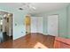 Bedroom with wood floors, ceiling fan, and access to bathroom at 131 114Th Ne Ter # 131, St Petersburg, FL 33716