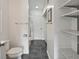 Bright bathroom with toilet, shower, and linen storage at 131 114Th Ne Ter # 131, St Petersburg, FL 33716