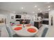 Open concept dining area with a white table and four gray chairs at 16784 Glacier Bay Loop, Wimauma, FL 33598