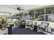 Relaxing screened porch with wicker furniture, ceiling fan, and view of the community at 18675 Us Highway 19 N # 488, Clearwater, FL 33764