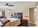 Cozy bedroom with a comfortable bed, dark wood furniture, and ceiling fan at 18675 Us Highway 19 N # 488, Clearwater, FL 33764