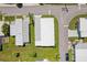 Aerial view of a mobile home community with lush landscaping and canal access at 18675 Us Highway 19 N # 488, Clearwater, FL 33764