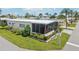 Single-story mobile home with screened porch and nicely landscaped yard at 18675 Us Highway 19 N # 488, Clearwater, FL 33764