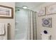 Clean bathroom with shower/tub combo, updated fixtures, and decorative wall art at 18675 Us Highway 19 N # 488, Clearwater, FL 33764