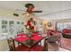 Dining area with dark wood table, red chairs and view of living room at 18675 Us Highway 19 N # 488, Clearwater, FL 33764