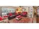 Living room with leather furniture, red accents, and area rug at 18675 Us Highway 19 N # 488, Clearwater, FL 33764