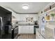 Bright kitchen with white cabinets, granite countertops, and black appliances at 18675 Us Highway 19 N # 488, Clearwater, FL 33764