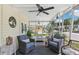 Bright screened porch with wicker furniture and ceiling fan, perfect for relaxing at 18675 Us Highway 19 N # 488, Clearwater, FL 33764
