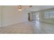 Bright living room with tile floors and a ceiling fan at 2043 Imperial Way, Clearwater, FL 33764