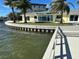 Waterfront backyard with private dock, retaining wall, and a view at 239 Punta Vista Dr, St Pete Beach, FL 33706
