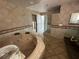 Large bathtub with tile surround, tile flooring, and a glass block shower at 239 Punta Vista Dr, St Pete Beach, FL 33706