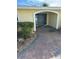 Inviting front entrance with an arched doorway and stone-paved walkway at 239 Punta Vista Dr, St Pete Beach, FL 33706