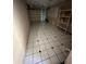 View of spacious garage with tiled flooring, storage, and a whiteboard at 239 Punta Vista Dr, St Pete Beach, FL 33706