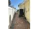 Paver walkway on the side of the home highlighting waterfront access and meticulous landscaping at 239 Punta Vista Dr, St Pete Beach, FL 33706
