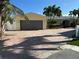 Charming home with a brick driveway, two-car garage, and lush landscaping, offering great curb appeal at 239 Punta Vista Dr, St Pete Beach, FL 33706