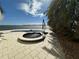 Waterfront backyard hot tub with views of the bay and palm trees at 239 Punta Vista Dr, St Pete Beach, FL 33706