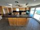 Retro kitchen with a large island, breakfast bar, and black tile countertops at 239 Punta Vista Dr, St Pete Beach, FL 33706