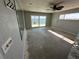 Bright living room featuring a ceiling fan, water view, and sliding glass door for natural light at 239 Punta Vista Dr, St Pete Beach, FL 33706