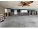 Spacious interior shows a ceiling fan, neutral wall paint, and door frames, needing renovation at 239 Punta Vista Dr, St Pete Beach, FL 33706