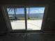 Sliding glass doors open to a paved patio and stunning waterfront scenery at 239 Punta Vista Dr, St Pete Beach, FL 33706