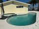 Backyard pool with a jacuzzi next to a bright yellow house at 239 Punta Vista Dr, St Pete Beach, FL 33706