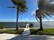 Beautiful waterfront view with a private dock and palm trees at 239 Punta Vista Dr, St Pete Beach, FL 33706