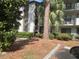 Two story building with balconies and landscaping at 3038 Eastland Blvd # F102, Clearwater, FL 33761