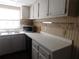 White cabinets and countertops, microwave, and window at 320 N Bayshore Blvd # 107, Clearwater, FL 33759