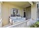 Relaxing porch swing on a covered front porch with white railings at 3407 Fox Squirrel Ln, Valrico, FL 33594