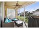 Relaxing screened patio with seating area, ceiling fan, and view of backyard at 3407 Fox Squirrel Ln, Valrico, FL 33594